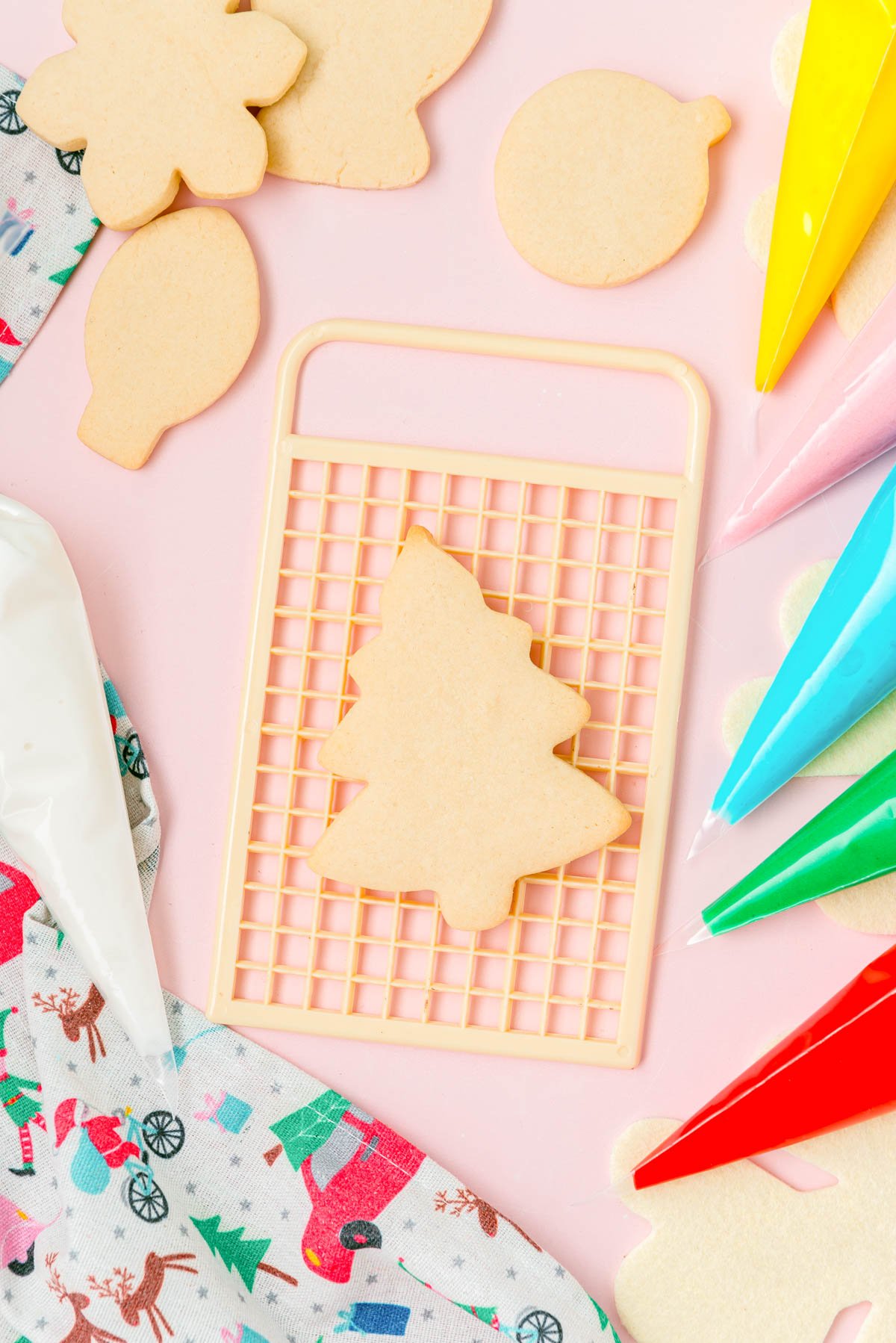 Overhead photo of cutout sugar cookies on a board ready to be frosted.