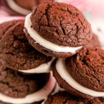 Close up photo of a pile of whoopie pies on a white plate.