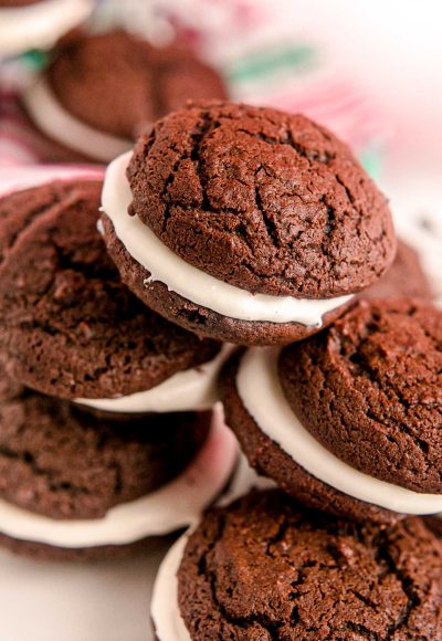 Close up photo of a pile of whoopie pies on a white plate.