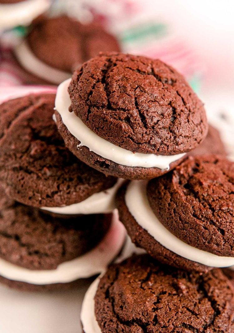 Close up photo of a pile of whoopie pies on a white plate.