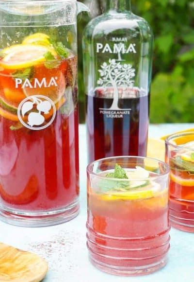 Celebrate summer with this Pomegranate Citrus Rum Punch! Sweet PAMA Pomegranate Liqueur paired with lemonade, lemon lime soda, and rum for a splash of summer fun.