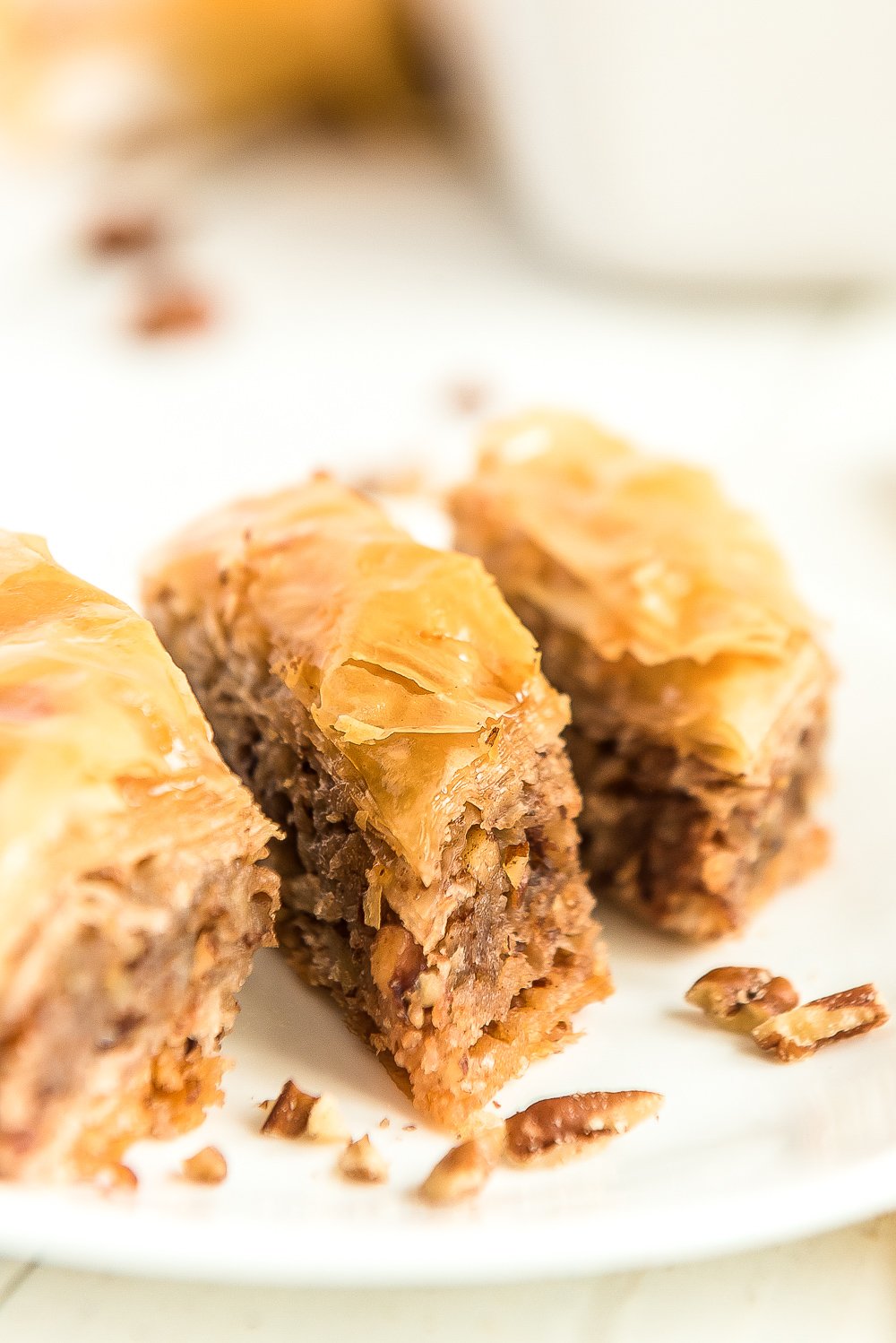 Three pieces of baklava on a white plate.