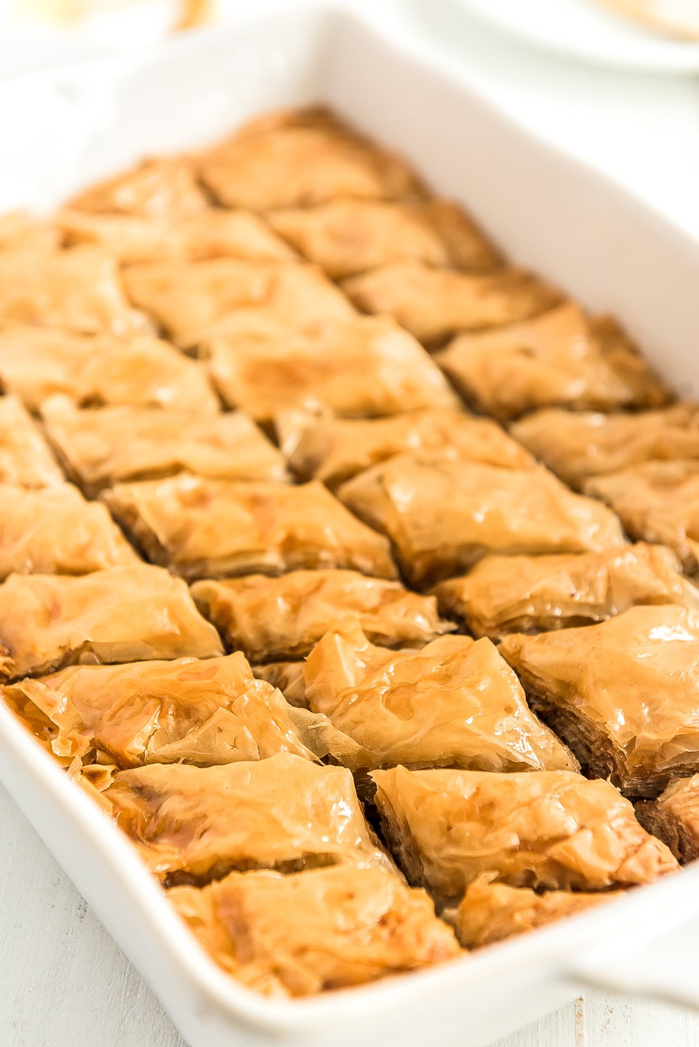 Baked baklava in a white baking dish.