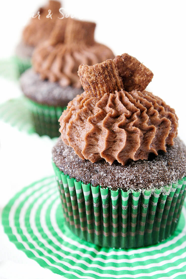 These Chocolate Cinnamon Toast Crunch Cupcakes are everything you loved about childhood rolled up into one! Moist chocolate cake loaded up with cinnamon and topped with a whipped chocolate frosting laced with cereal pieces!