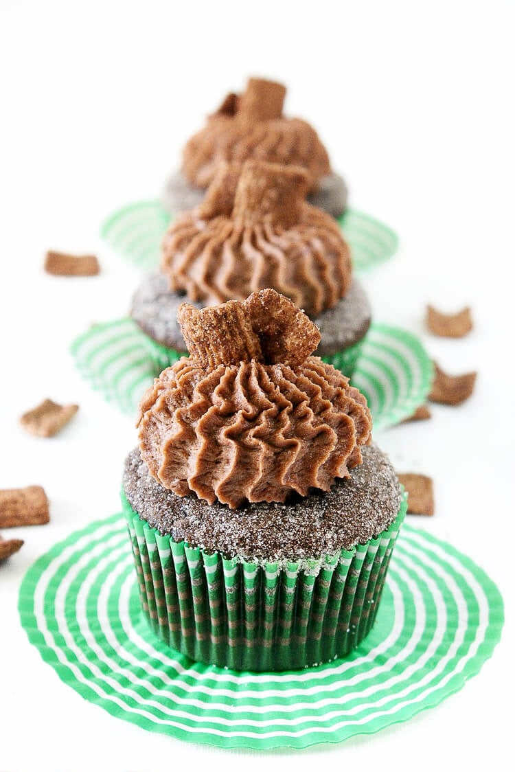 These Chocolate Cinnamon Toast Crunch Cupcakes are everything you loved about childhood rolled up into one! Moist chocolate cake loaded up with cinnamon and topped with a whipped chocolate frosting laced with cereal pieces!