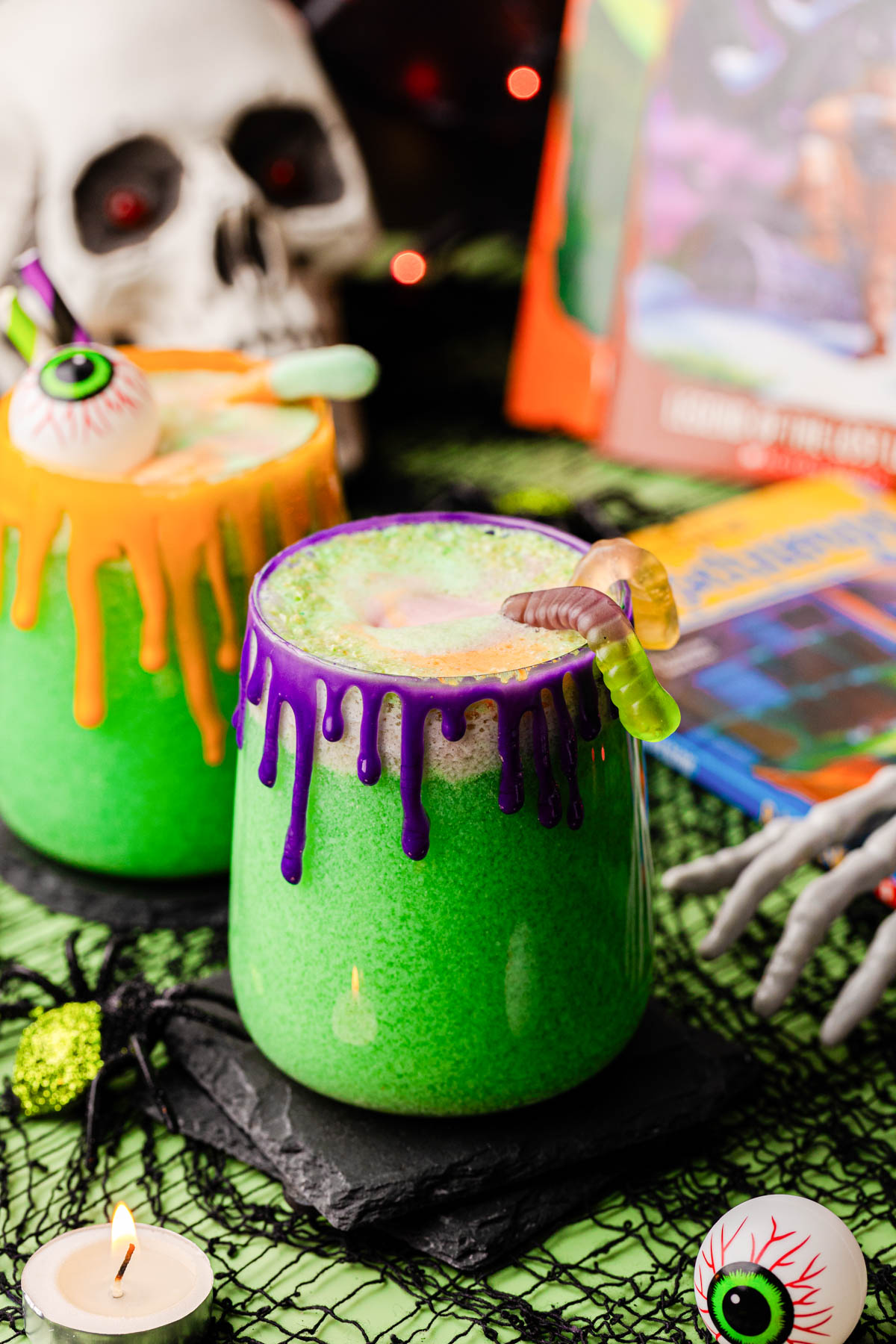 Two glasses of green Goosebumps punch for Halloween on a table.