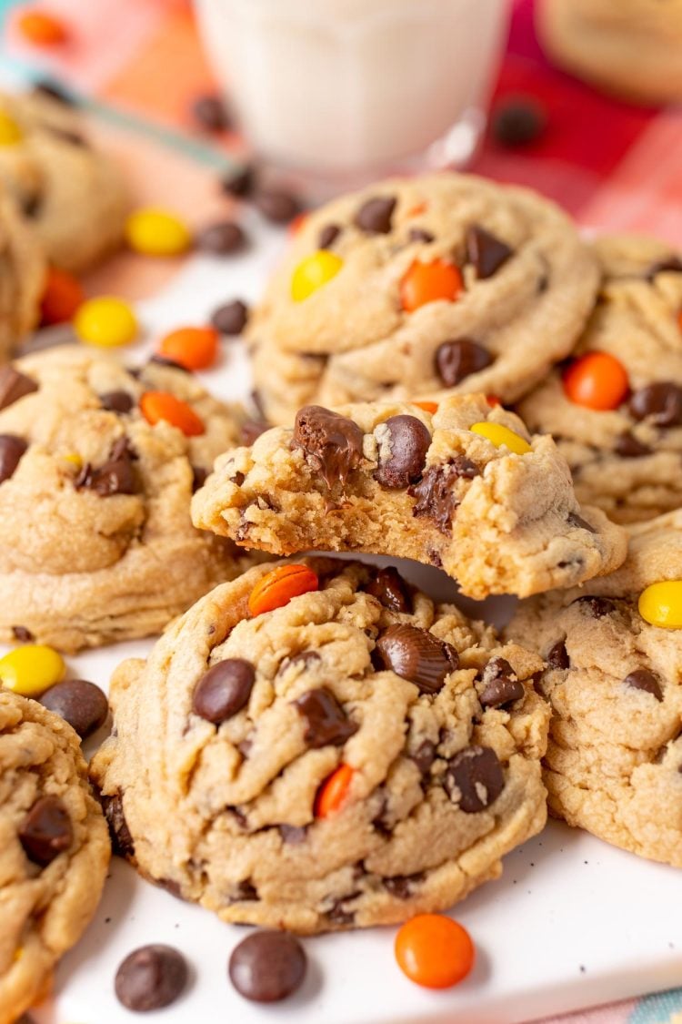 Reese's Pieces Peanut Butter Cookies on a serving tray, one has a bite taken out of it.