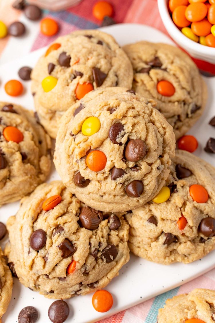 Peanut Butter chocolate chip cookies with reese's pieces on a white serving tray.