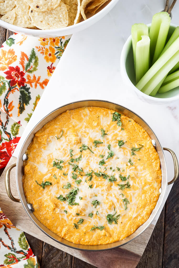 This Baked Buffalo Chicken Dip is made with real cream and blue cheeses, rotisserie chicken, hot sauce and spices for a sensational appetizer that's sure to please! Plus, it's ready in less than 30 minutes!