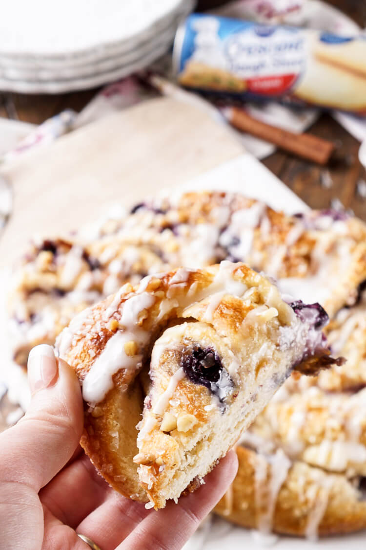 This Blueberry Spice Cream Cheese Breakfast Ring is the perfect addition to a holiday brunch. A simple and sweet filling is wrapped up in crescent dough and topped with chopped pecans and icing for a delicious morning pastry the whole family can enjoy!