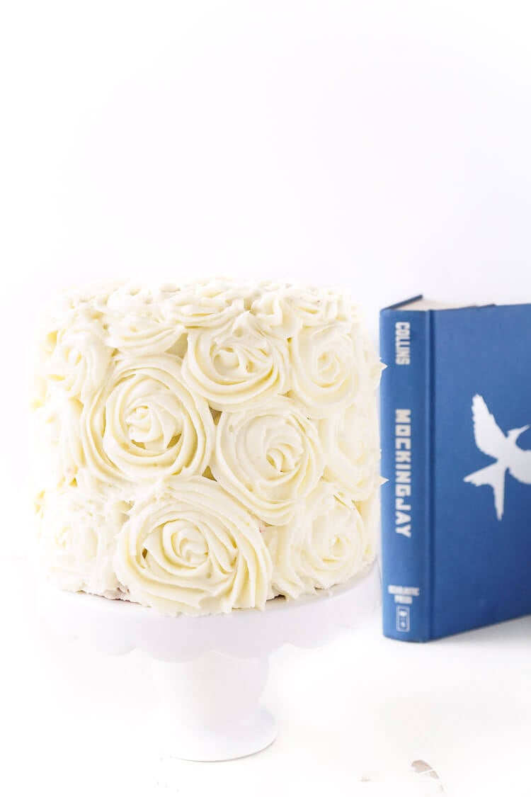 Red Velvet Cake, aka President Snow's White Rose Cake, is a red velvet cake frosted in cream cheese buttercream and inspired by The Hunger Games trilogy and perfect for Valentine's Day too!