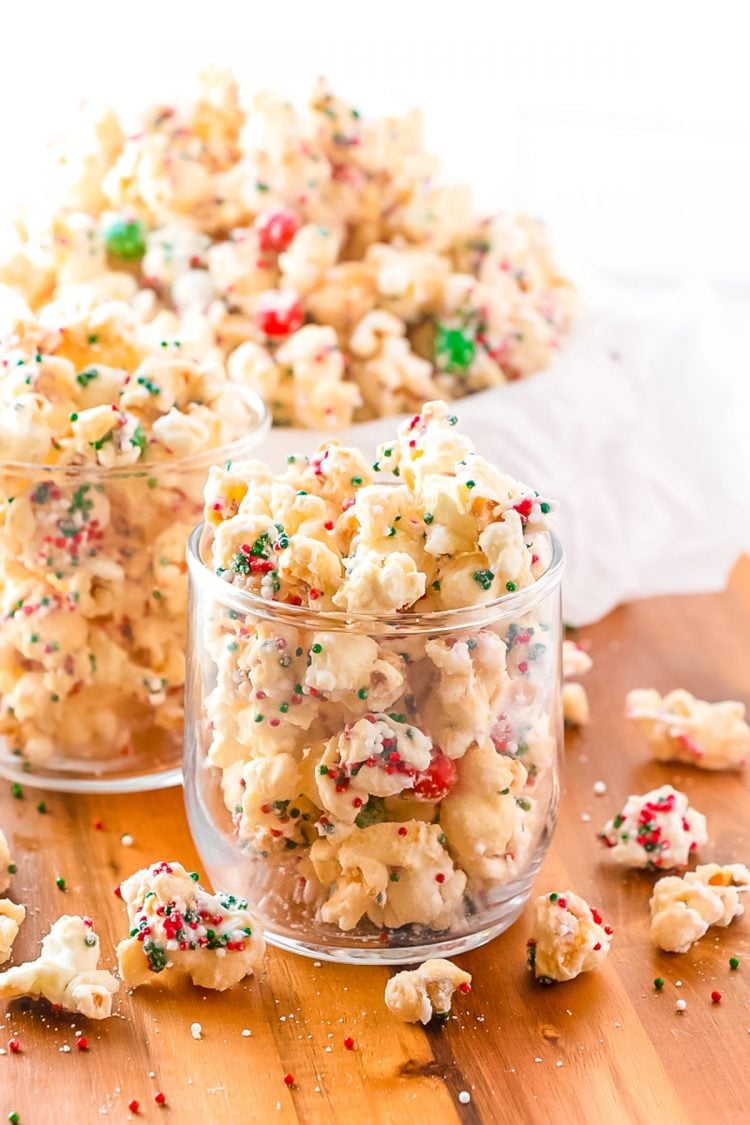 Christmas popcorn mixture being served in glasses.