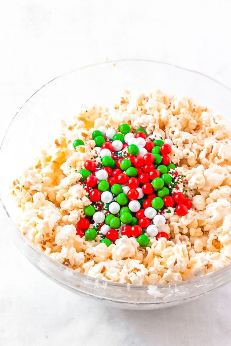Candy and popcorn in a glass mixing bowl.