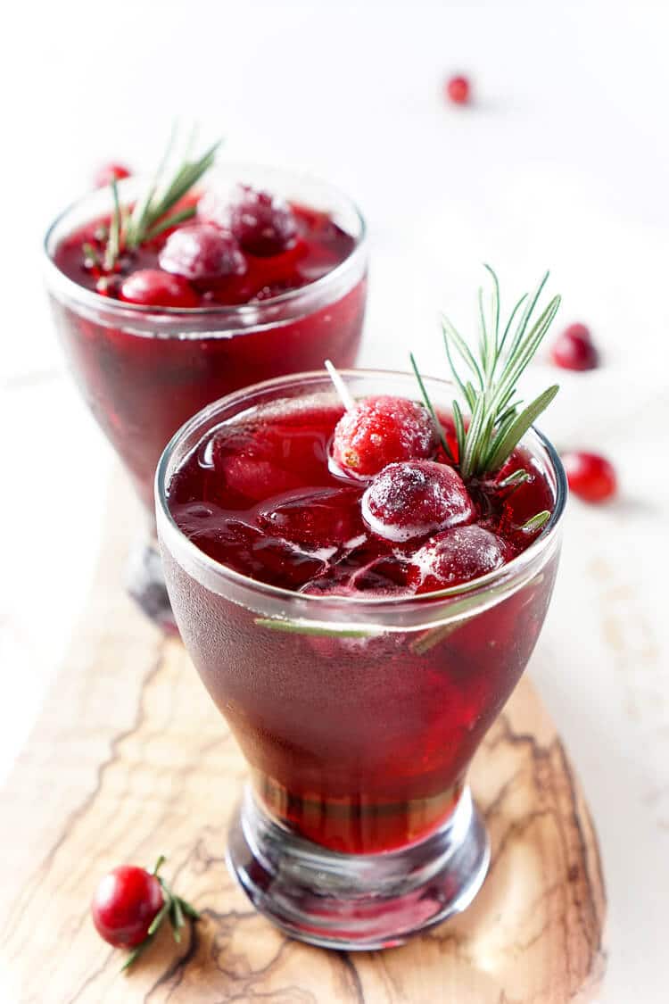 This Cranberry Cooler recipe is refreshing and delicious with just a handful of ingredients that will have you feeling festive in no time! Cranberries, sugar, and a dash of peppermint combine for a non-alcoholic drink that's both tart and crisp. Make it for Christmas or NYE!