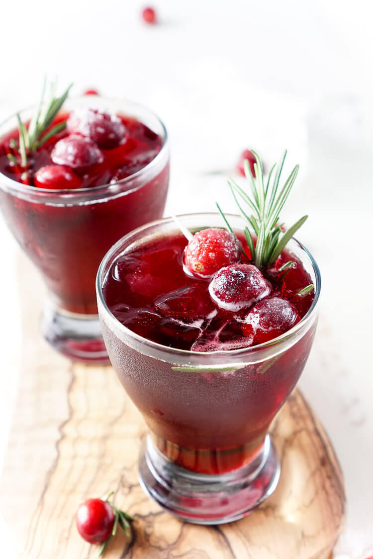 This Cranberry Cooler recipe is refreshing and delicious with just a handful of ingredients that will have you feeling festive in no time! Cranberries, sugar, and a dash of peppermint combine for a non-alcoholic drink that's both tart and crisp. Make it for Christmas or NYE!
