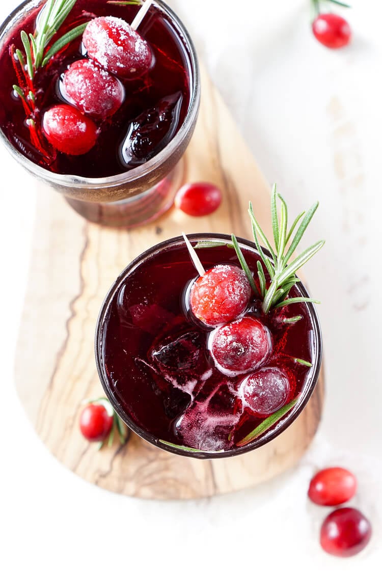 This Cranberry Cooler recipe is refreshing and delicious with just a handful of ingredients that will have you feeling festive in no time! Cranberries, sugar, and a dash of peppermint combine for a non-alcoholic drink that's both tart and crisp. Make it for Christmas or NYE!