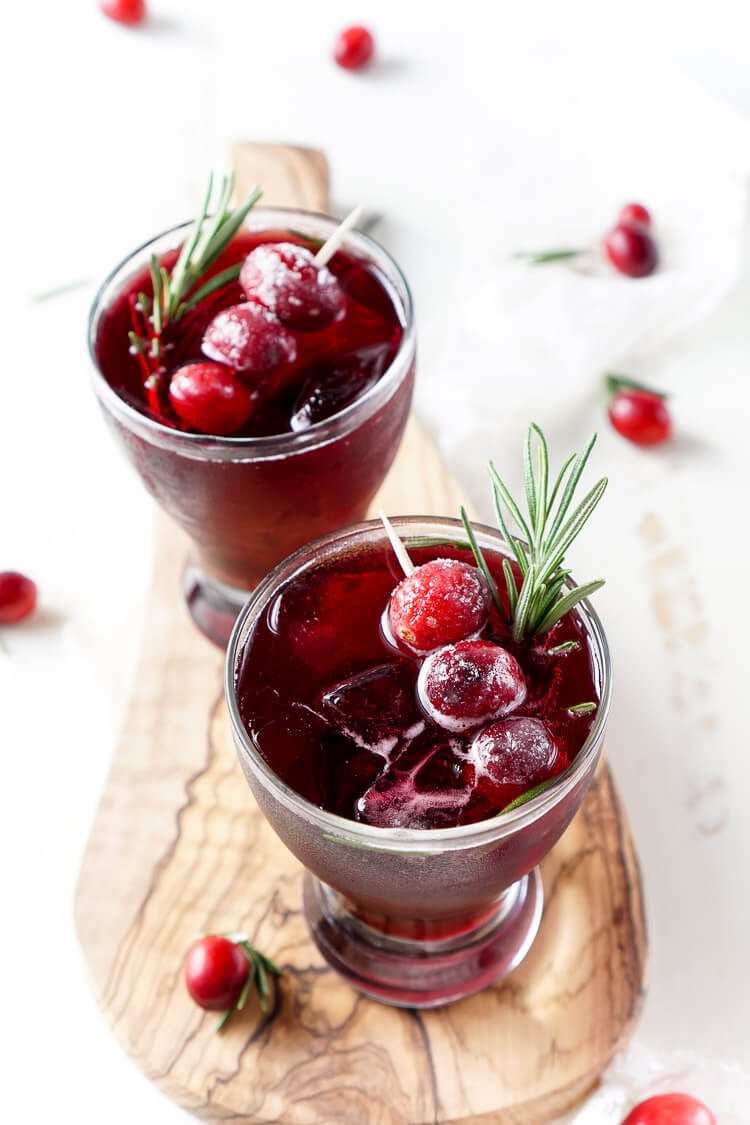 This Cranberry Cooler recipe is refreshing and delicious with just a handful of ingredients that will have you feeling festive in no time! Cranberries, sugar, and a dash of peppermint combine for a non-alcoholic drink that's both tart and crisp. Make it for Christmas or NYE!