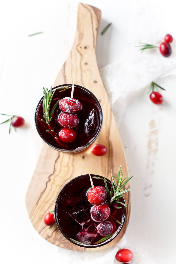 This Cranberry Cooler recipe is refreshing and delicious with just a handful of ingredients that will have you feeling festive in no time! Cranberries, sugar, and a dash of peppermint combine for a non-alcoholic drink that's both tart and crisp. Make it for Christmas or NYE!