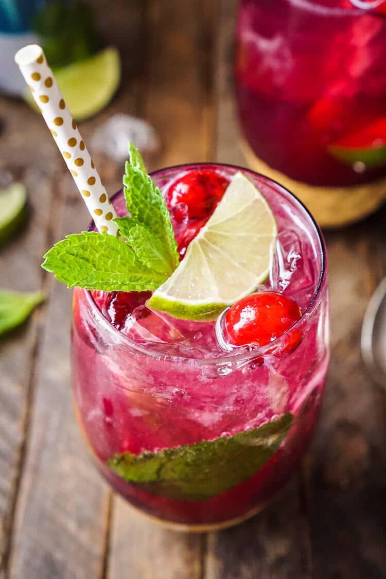 This Cranberry Mojito Punch is so refreshing and flavorful! It's a festive sparkling cocktail that's sure to have everyone dancing the night away at your holiday party! The red and green make it the perfect Christmas cocktail recipe!