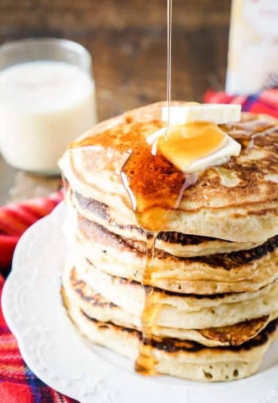 These Eggnog Ricotta Pancakes are fluffy and full of holiday flavor! Made with a creamy eggnog and ricotta base, these cook right up in minutes and make a fantastic holiday breakfast! Top them with butter, syrup, and whipped cream!