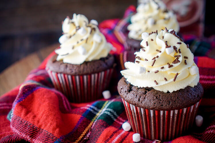 These Hot Chocolate Cupcakes are made with actual hot chocolate in the batter, filled with marshmallow fluff, and finished with a vanilla whipped cream frosting! They're everything you love about the classic drink in cupcake form, a perfect winter and holiday dessert!