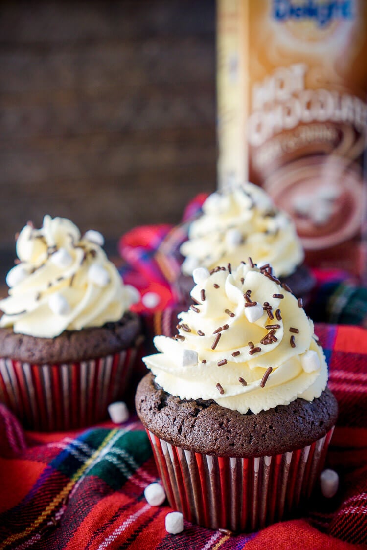 These Hot Chocolate Cupcakes are made with actual hot chocolate in the batter, filled with marshmallow fluff, and finished with a vanilla whipped cream frosting! They're everything you love about the classic drink in cupcake form, a perfect winter and holiday dessert!