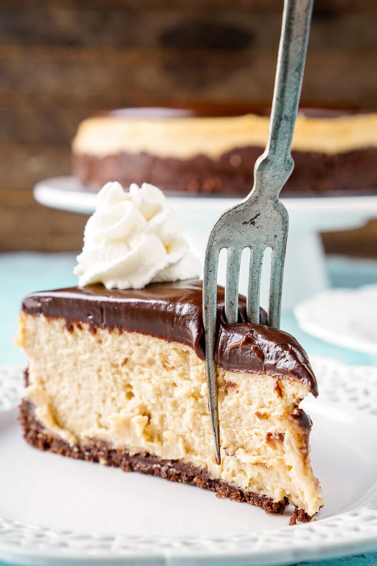 This Peanut Butter Chocolate Cheesecake recipe is a silky, peanut buttery dessert sandwiched between a chocolate graham cracker crust and a tempting chocolate ganache.