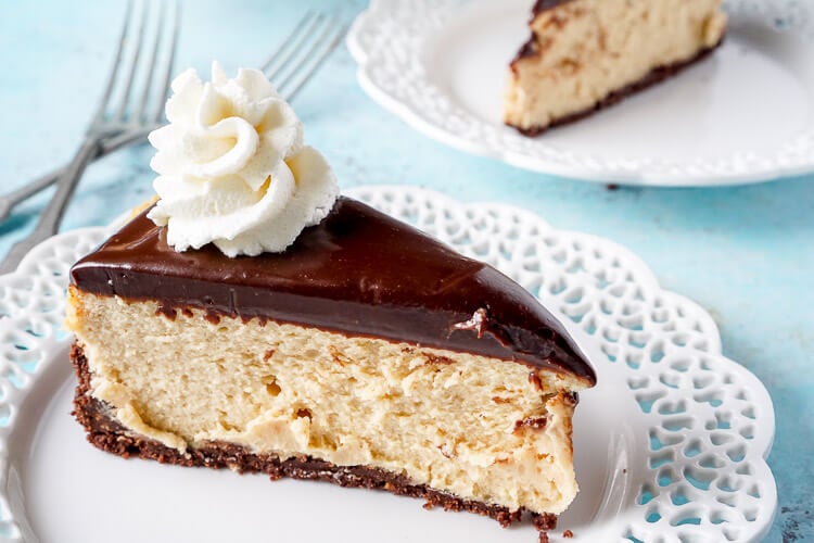 This Peanut Butter Chocolate Cheesecake recipe is a silky, peanut buttery dessert sandwiched between a chocolate graham cracker crust and a tempting chocolate ganache.