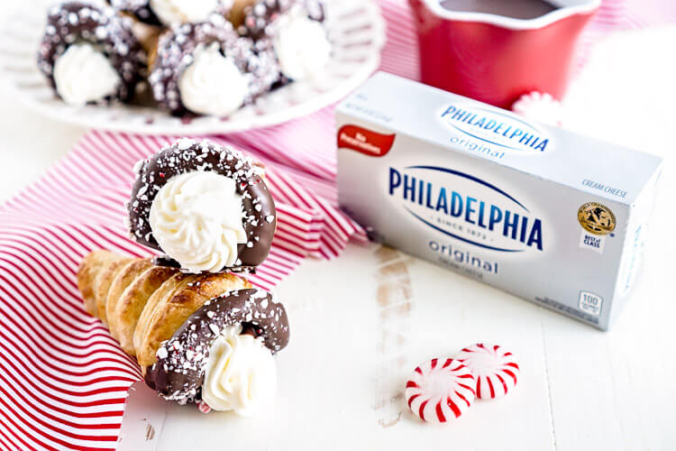 These Chocolate Peppermint Cheesecake Cream Horns are a simple dessert with a flaky pastry that’s been dipped in chocolate, sprinkled with peppermint candy pieces, and finished with a peppermint cream cheese filling.