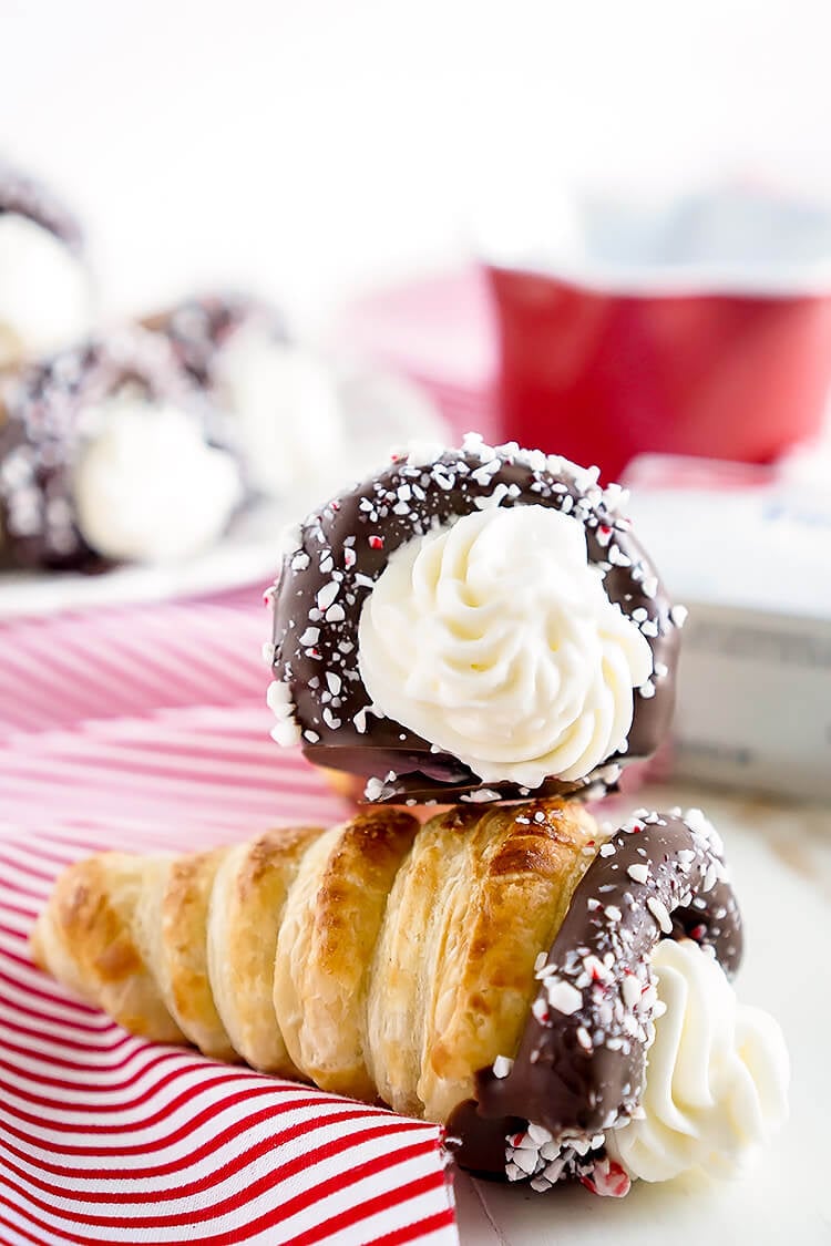 These Chocolate Peppermint Cheesecake Cream Horns are a simple dessert with a flaky pastry that’s been dipped in chocolate, sprinkled with peppermint candy pieces, and finished with a peppermint cream cheese filling.