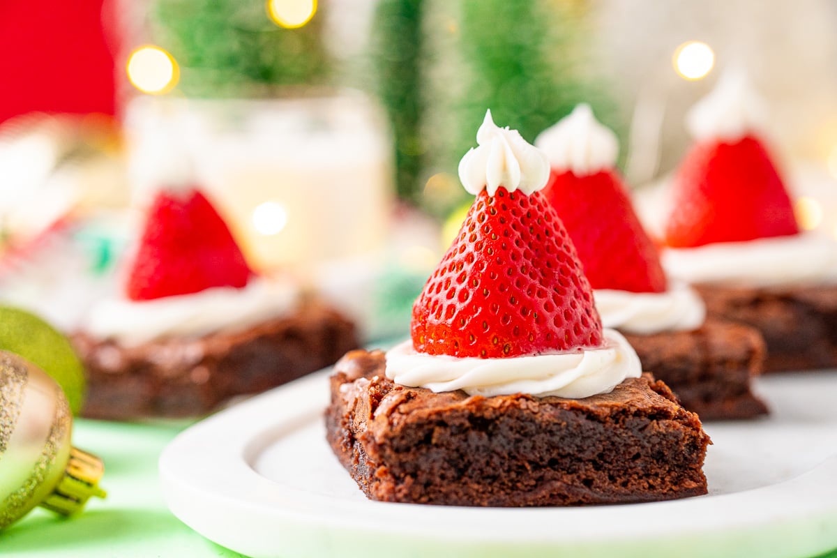 These Santa Hat Brownies are a simple and festive rich chocolate dessert the whole family will love! Perfect for parties and family get-togethers!