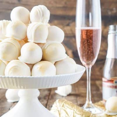 These Strawberries & Champagne Cake Balls are perfect for a New Year's Eve party, Valentine's Day, Bridal Showers and so much more! They make an easy dessert that tastes like fruity pebbles!