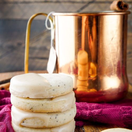 Four Vanilla Chai Cookies Stacked in front of of a copper mug