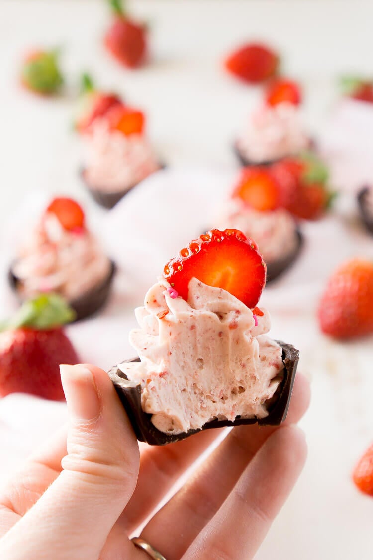 These Strawberry Mousse Cups are an easy dessert! A fluffy strawberry mousse is served in chocolate shells for a fun and simple treat that's great for Valentine's Day, baby showers, bridal showers, or anything else!