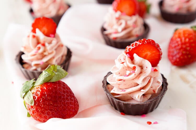 These Strawberry Mousse Cups are an easy dessert! A fluffy strawberry mousse is served in chocolate shells for a fun and simple treat that's great for Valentine's Day, baby showers, bridal showers, or anything else!