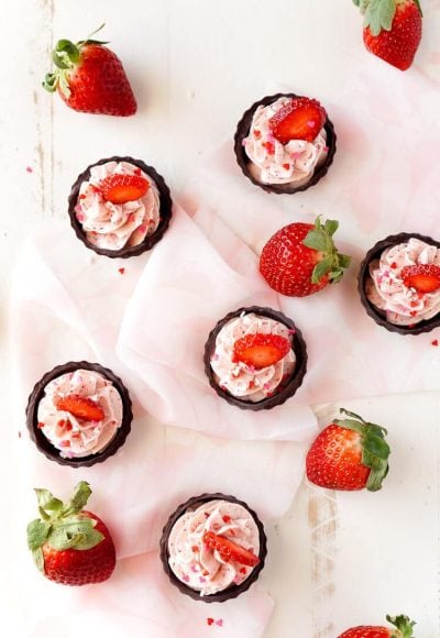 These Strawberry Mousse Cups are an easy dessert! A fluffy strawberry mousse is served in chocolate shells for a fun and simple treat that's great for Valentine's Day, baby showers, bridal showers, or anything else!