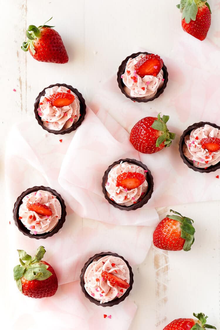 These Strawberry Mousse Cups are an easy dessert! A fluffy strawberry mousse is served in chocolate shells for a fun and simple treat that's great for Valentine's Day, baby showers, bridal showers, or anything else!