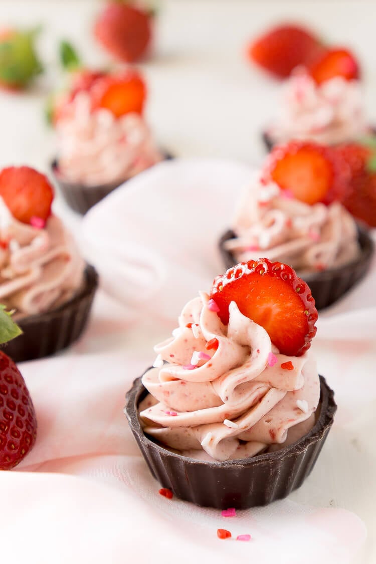 These Strawberry Mousse Cups are an easy dessert! A fluffy strawberry mousse is served in chocolate shells for a fun and simple treat that's great for Valentine's Day, baby showers, bridal showers, or anything else!