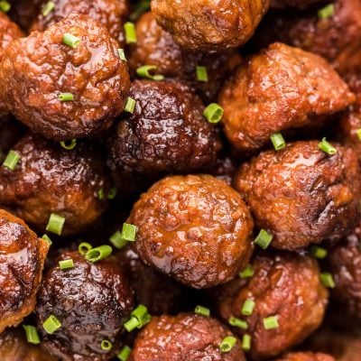 Close up photo of meatballs garnished with chives.