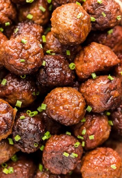 Close up photo of meatballs garnished with chives.