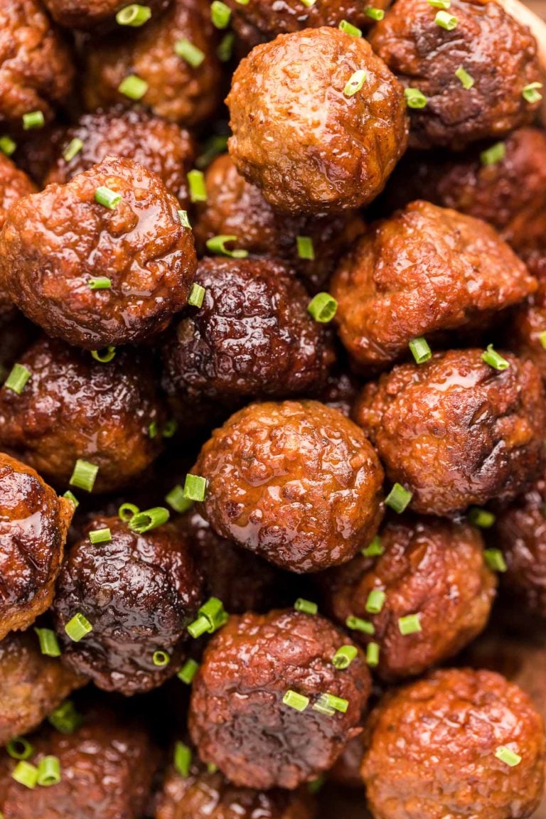 Close up photo of meatballs garnished with chives.