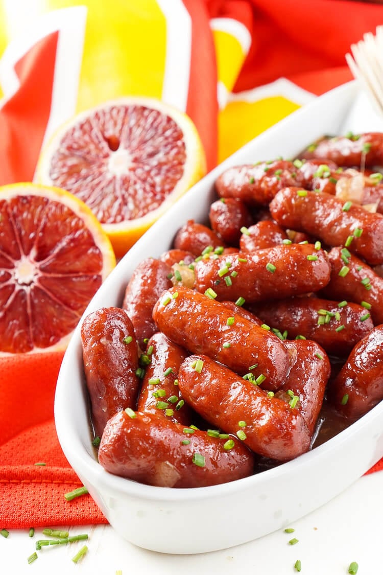 These Spicy Blood Orange Lit'l Smokies sausages are an easy appetizer with an Asian flair and a hint of heat that's perfect for game days! Made in the crock pot and ready in less than 2 hours!