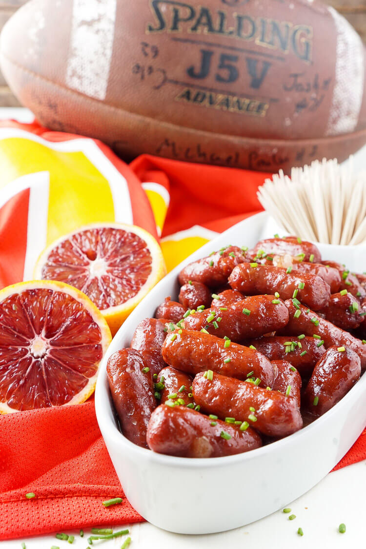 These Spicy Blood Orange Lit'l Smokies sausages are an easy appetizer with an Asian flair and a hint of heat that's perfect for game days! Made in the crock pot and ready in less than 2 hours!
