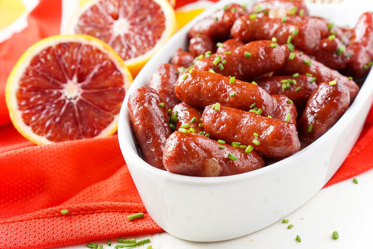 These Spicy Blood Orange Lit'l Smokies sausages are an easy appetizer with an Asian flair and a hint of heat that's perfect for game days! Made in the crock pot and ready in less than 2 hours!