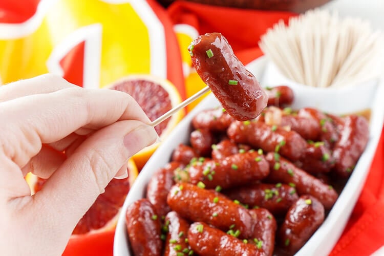 These Spicy Blood Orange Lit'l Smokies sausages are an easy appetizer with an Asian flair and a hint of heat that's perfect for game days! Made in the crock pot and ready in less than 2 hours!