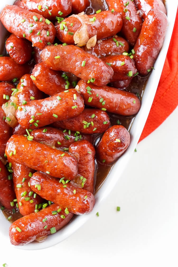 These Spicy Blood Orange Lit'l Smokies sausages are an easy appetizer with an Asian flair and a hint of heat that's perfect for game days! Made in the crock pot and ready in less than 2 hours!