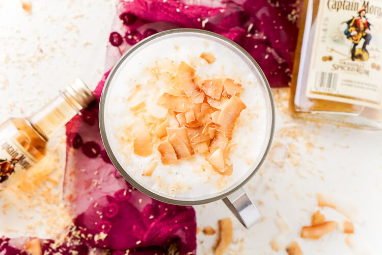 This Spiked Coconut Vanilla Steamer is one of the coziest winter cocktails you'll ever have! Made with real vanilla beans, coconut, milk, and spiced rum! It's delicious and frothy and topped with toasted coconut!