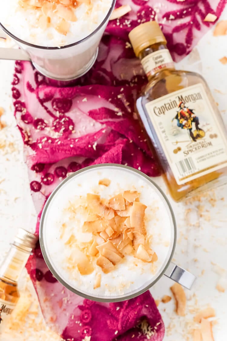 This Spiked Coconut Vanilla Steamer is one of the coziest winter cocktails you'll ever have! Made with real vanilla beans, coconut, milk, and spiced rum! It's delicious and frothy and topped with toasted coconut!