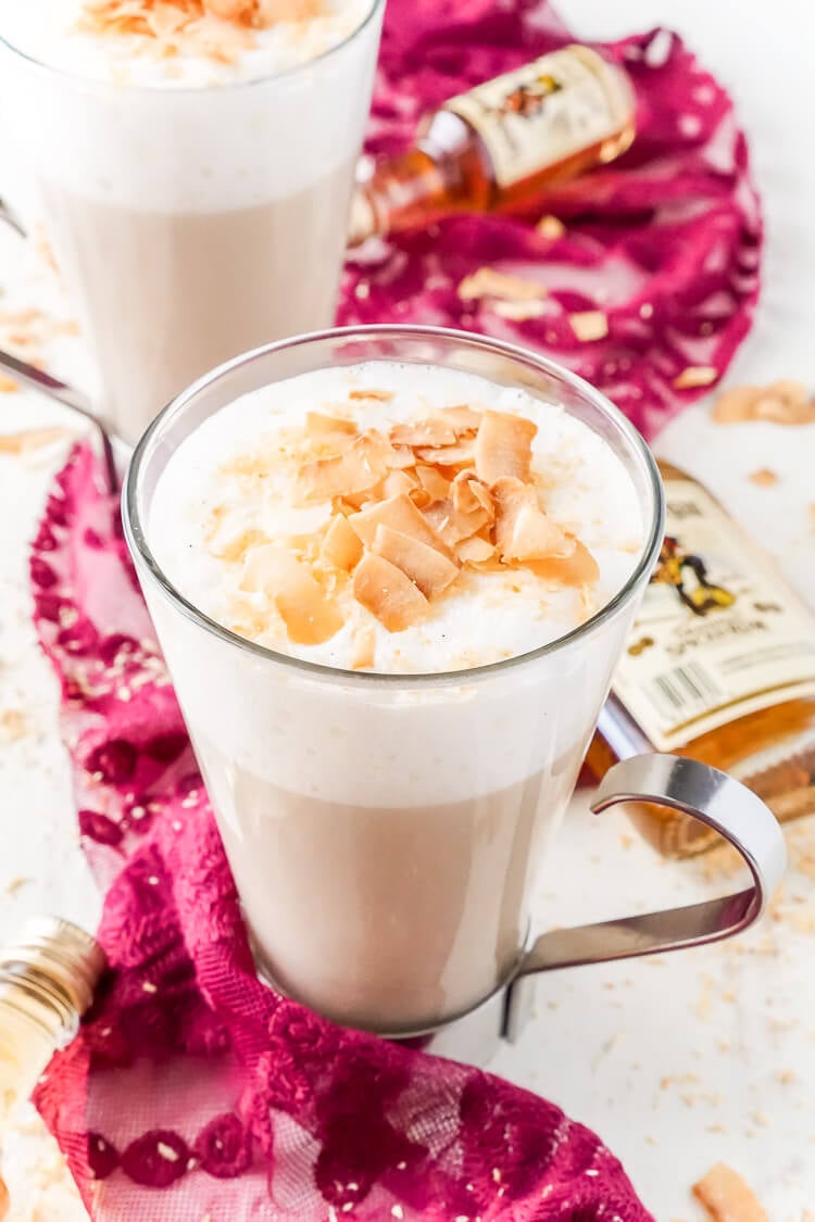 This Spiked Coconut Vanilla Steamer is one of the coziest winter cocktails you'll ever have! Made with real vanilla beans, coconut, milk, and spiced rum! It's delicious and frothy and topped with toasted coconut!