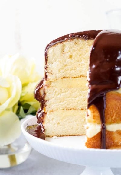 This Triple Layer Boston Cream Pie is a CLASSIC if there ever was one! A delicious rum infused cake, topped with vanilla bean pastry cream and homemade chocolate ganache! A rich and wonderful New England dessert!